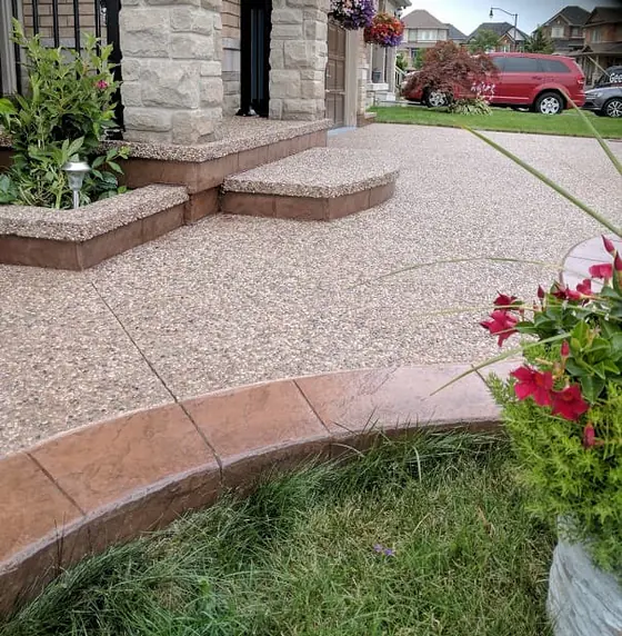 Aggregate walkway and curved steps with a reddish brown border
