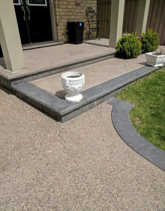 Aggregate driveway and porch with a dark concrete border