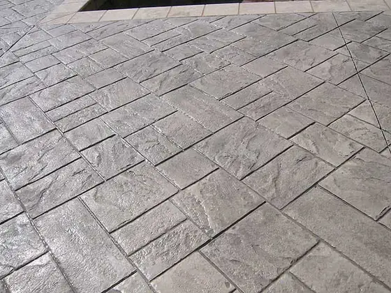 Close view of a grey stamped concrete surface and pattern