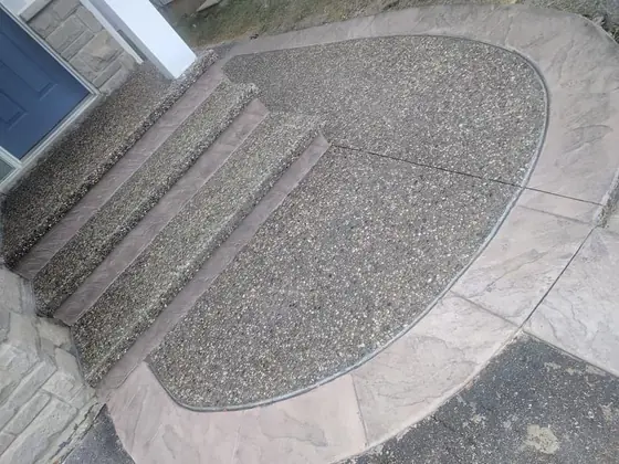 Exposed aggregate entrance with rounded concrete steps