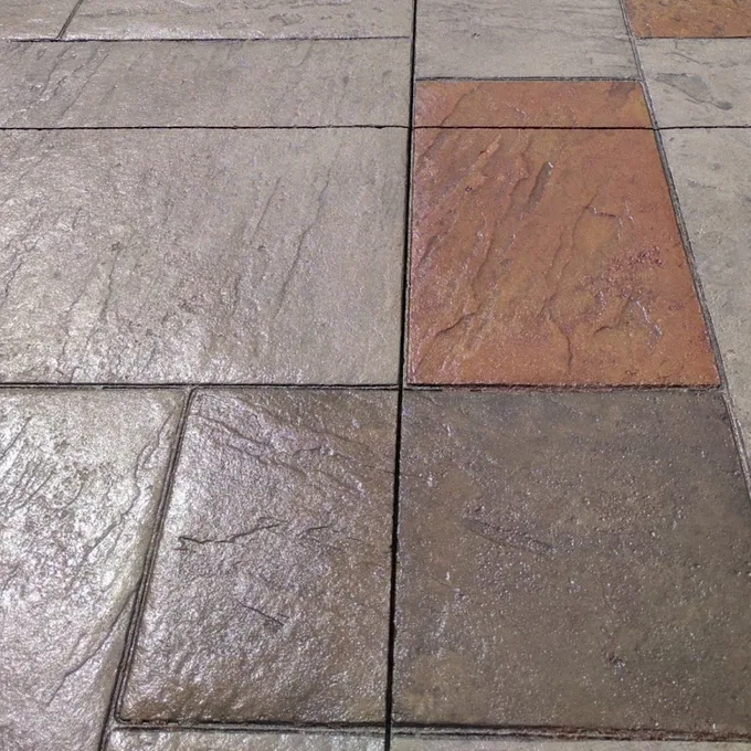 Grey and terracotta stamped concrete after sealing, with richer colour and a glossy finish